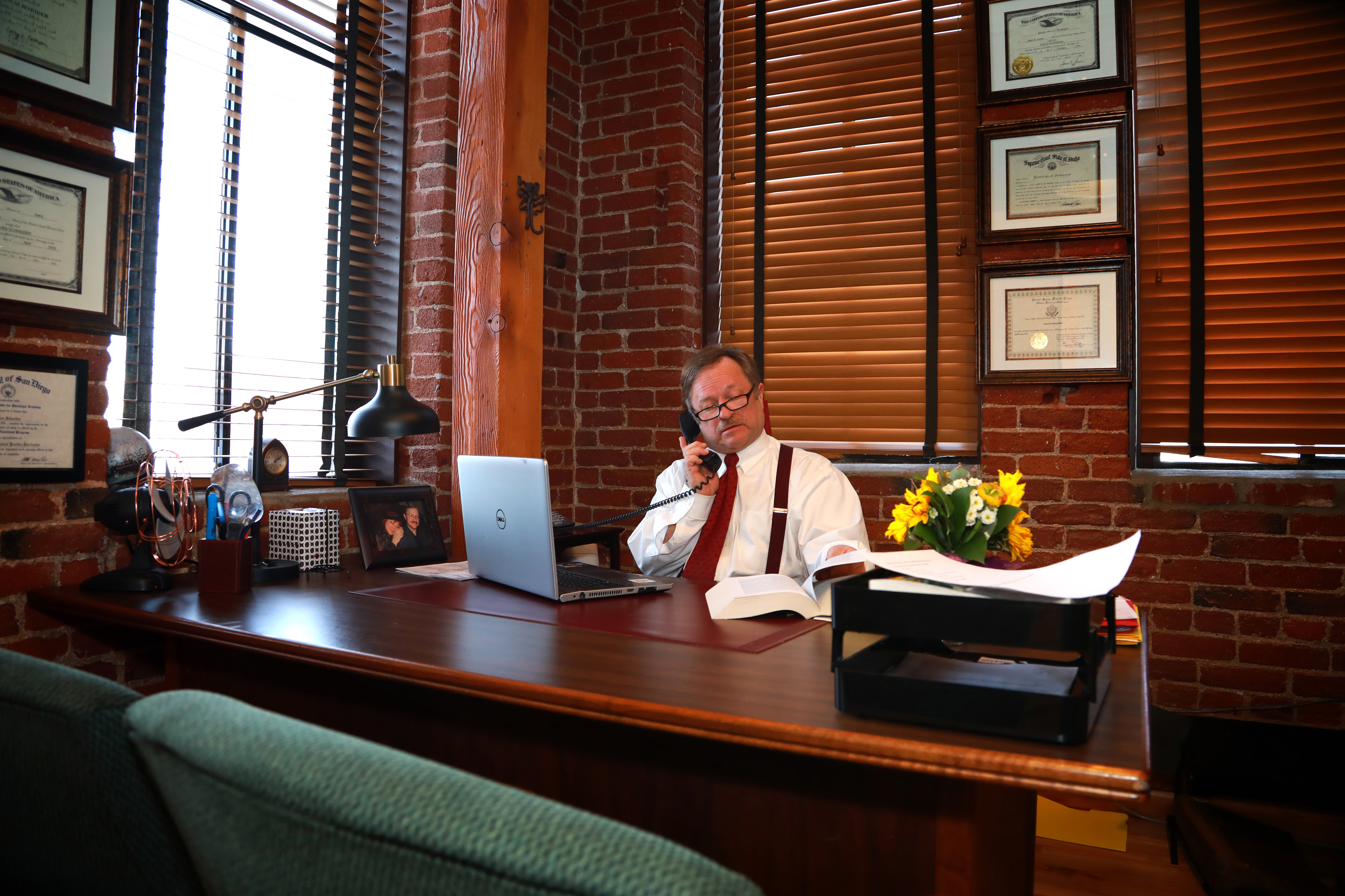 Steven Schneider, Attorney at Law, on phone at desk